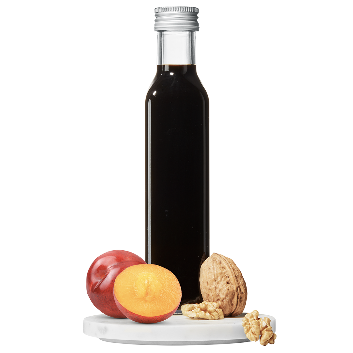 A bottle of Plum Walnut Vinegar with a small plate containing sliced plum and walnut pieces in front.