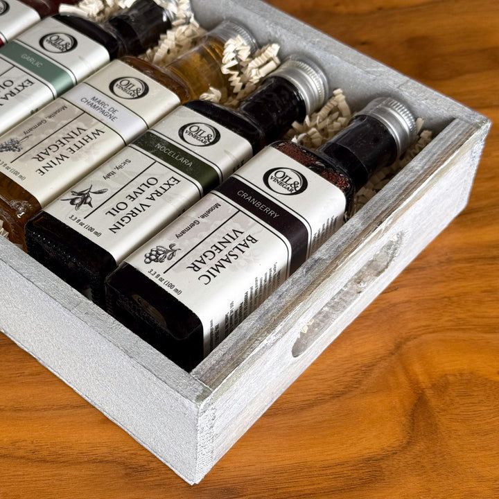 Three bottles of sauces with labels on a gray background