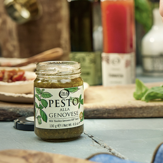 A glass jar of Pesto alla Genovese with a black lid, labeled with the product name and the weight of 130g.
