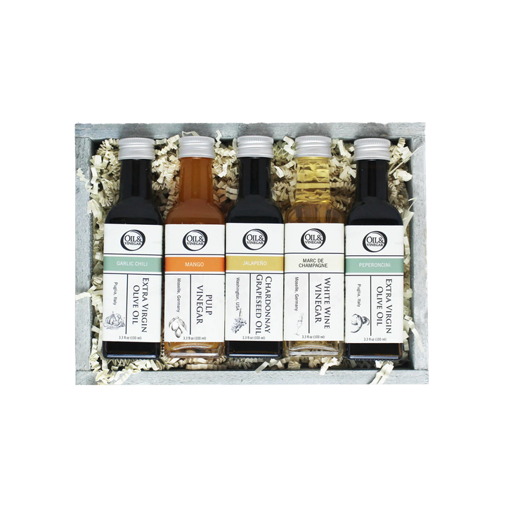 Set of five olive oil and vinegar bottles in a wooden box
