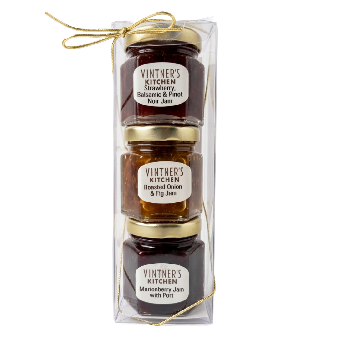 A three-pack of Vintner's Kitchen jams in a clear plastic gift box with a gold ribbon, containing Strawberry Balsamic & Pinot Noir Jam, Roasted Onion & Fig Jam, and Marionberry Jam with Port.