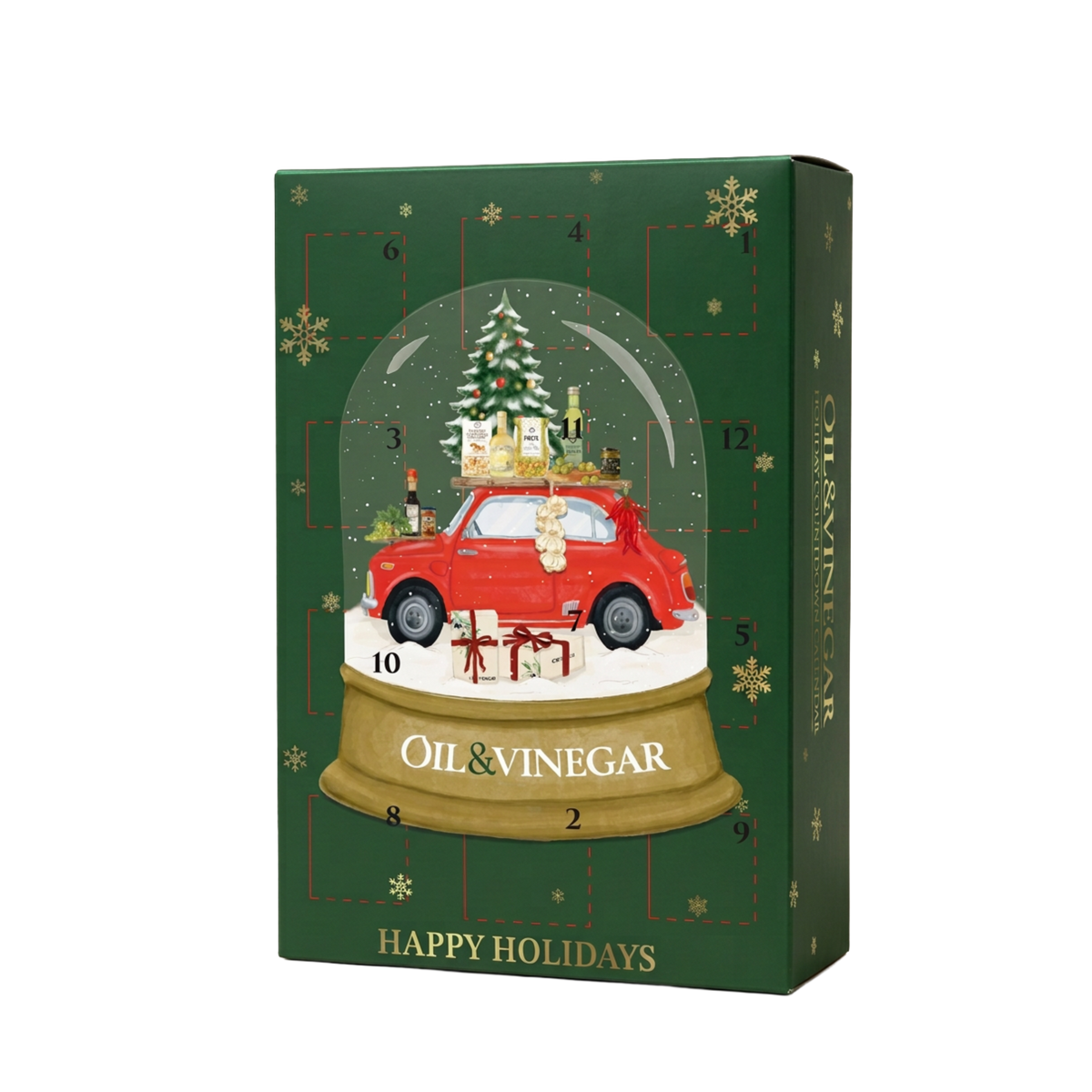 A Christmas advent calendar box with a dark green background, gold snowflakes, and a central illustration of a red car inside a snow globe with a Christmas tree and gifts. The box is labeled 'OIL & VINEGAR' and 'HAPPY HOLIDAYS'.