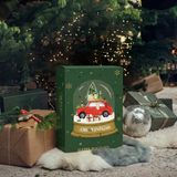 A green Christmas advent-style gift box labeled 'Oil & Vinegar' stands on a rug in front of a decorated Christmas tree, surrounded by wrapped presents, a fur throw, and a silver disco ball.